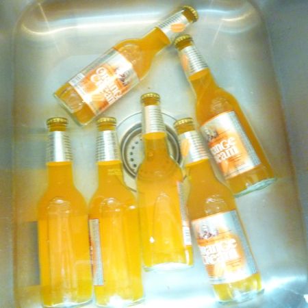 Soak glass bottle with labels overnight in water